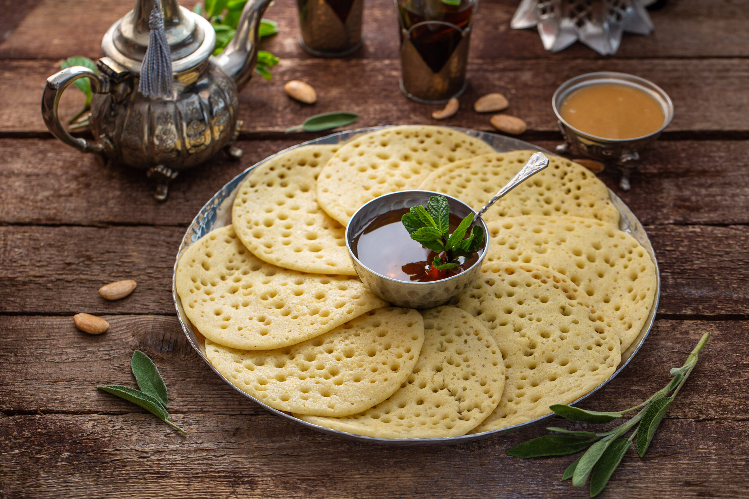 Moroccan pancakes Baghrir served with almond paste, honey and mint tea.